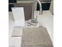 Contemporary kitchen materials including a sleek stainless steel faucet, bright white quartz, and pleasant colored flooring at 2775 Fantoni St, Henderson, NV 89044