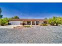 Charming single-story home with desert landscaping, covered porch and two-car garage at 291 E Hickory St, Pahrump, NV 89048