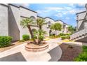 Exterior view showing the manicured grounds and building facade under a sunny sky at 3150 Soft Breezes Dr # 1216, Las Vegas, NV 89128
