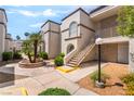 Exterior view showcasing the building's architectural details, landscaping, and walkway at 3150 Soft Breezes Dr # 1216, Las Vegas, NV 89128