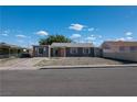 Quaint single-story home boasts a gray exterior with a concrete driveway and simple landscaping at 321 Princess Ave, North Las Vegas, NV 89030