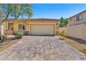 Charming single-story home featuring a spacious two-car garage and a brick-paved driveway at 3521 Discovery Downs Ct, North Las Vegas, NV 89081