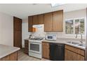 Cozy kitchen featuring classic cabinetry, stainless steel appliances, and a bright window above the sink at 421 Carlin Ave, Las Vegas, NV 89110