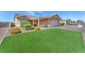 Inviting single level home showcasing a pristine lawn and covered patio at 452 Waterwheel Falls Dr, Henderson, NV 89015