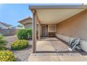 Welcoming covered porch area with a seating bench and tidy landscaping at 452 Waterwheel Falls Dr, Henderson, NV 89015