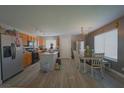 Bright open floor plan connecting the kitchen and dining area, ideal for Gathering gatherings and casual dining at 6002 Stone Hollow Ave, Las Vegas, NV 89156