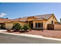 Charming single-story home featuring a tile roof, desert landscaping, and a three-car garage at 6016 Bungalow Bay St, Las Vegas, NV 89130