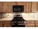 The kitchen is equipped with custom wood cabinets, stainless appliances and granite counter tops at 6016 Bungalow Bay St, Las Vegas, NV 89130