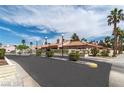 Scenic street view showcasing well-maintained homes, lush palm trees, and inviting sidewalks at 613 Cervantes Dr, Henderson, NV 89014