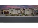 Attractive single-story home featuring a tile roof, arched windows, manicured landscaping, and a two-car garage at 6333 Orto Vaso Ave, Las Vegas, NV 89131