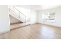 Spacious living room features hardwood floors, staircase, and natural light from the window at 637 Otono Dr, Boulder City, NV 89005