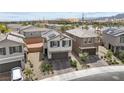 Aerial view of a home showcasing solar panels, a two-car garage, and a landscaped yard at 6611 Dove Point Pl, Las Vegas, NV 89130