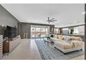 Spacious living room with stylish decor, large windows, and a seamless flow to the outdoor patio at 6834 Fallen Rock St, North Las Vegas, NV 89084