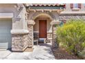 Close up of the entryway with decorative stone pillars and tile roof at 7194 Clear Range Ave, Las Vegas, NV 89178