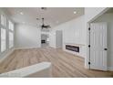 Open-concept living room with hardwood floors and built-in entertainment center at 7460 Desert Flame Ct, Las Vegas, NV 89149