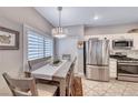 Eat-in kitchen with stainless steel appliances, and a dining area with shuttered windows at 76 Stock Option St # 2, Henderson, NV 89074