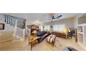 Spacious living room with staircase, tiled floors, recessed lighting, and modern decor at 76 Stock Option St # 2, Henderson, NV 89074