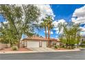 A well-manicured, single-story home boasting a two-car garage, desert landscaping and a neutral color palette at 7730 Brambly Creek Ct, Las Vegas, NV 89129