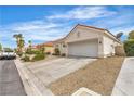 Single-story home with a two-car garage, desert landscaping, and a spacious driveway at 7929 Ben Hogan Dr, Las Vegas, NV 89149