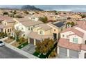 Neighborhood aerial view featuring desert landscaping, mountain views, tile roofs, and solar panels at 852 Colina Alta Pl, Las Vegas, NV 89138