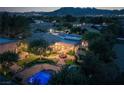 Expansive backyard featuring a pool, fountain, pergola, and lush landscaping with mountain views at 8620 W La Madre Way, Las Vegas, NV 89149