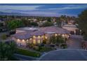 Beautiful single-story home featuring lush landscaping, stone accents, and a circular driveway with mountain views at 8620 W La Madre Way, Las Vegas, NV 89149