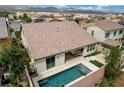 Aerial view of the backyard with a swimming pool, patio area with furniture, and landscaped surroundings at 1005 Old Creek Way, North Las Vegas, NV 89084