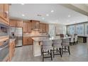 Spacious kitchen with granite countertops, stainless steel appliances, an island with seating, and recessed lighting at 1005 Old Creek Way, North Las Vegas, NV 89084