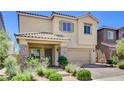 Charming two-story home featuring a stucco exterior, stone accents, and a well-manicured front yard at 1055 Fish Pond Ave, Henderson, NV 89014