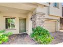 Inviting front porch with stone pillar accents and a brick-paved walkway leading to the front door at 1055 Fish Pond Ave, Henderson, NV 89014
