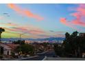 Scenic street view overlooking the Las Vegas skyline at sunset with clear, colorful skies at 10901 Fort Valley Ave, Las Vegas, NV 89134