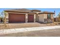 Beautiful single-story home with a two-car garage and a nicely landscaped front yard at 1220 Eva Creek Dr # 35, North Las Vegas, NV 89084