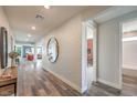 Bright hallway with decorative mirror and accent wall that leads to other rooms of the house at 1220 Eva Creek Dr # 35, North Las Vegas, NV 89084