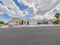 A charming single-story home with a two-car garage and desert landscaping at 1305 Pagentry Dr, North Las Vegas, NV 89031