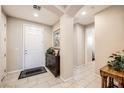 Bright foyer featuring tile flooring, neutral paint, and direct access to living spaces at 1641 Blue Cliffs Ave, Henderson, NV 89014