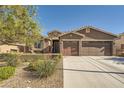 Charming single-story home with stone accents, a three-car garage, and desert landscaping at 1641 Blue Cliffs Ave, Henderson, NV 89014