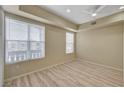 Spacious bedroom features wood floors, neutral walls, large bright windows, and ceiling fan at 20 E Serene Ave # 401, Las Vegas, NV 89123