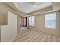 Bright bedroom featuring wood floors, neutral walls, and sliding glass door access to balcony at 20 E Serene Ave # 401, Las Vegas, NV 89123