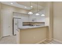 Kitchen featuring white cabinets, granite countertops, microwave, refrigerator, and pendant lighting at 20 E Serene Ave # 401, Las Vegas, NV 89123