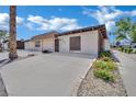 Tan single-story home with simple landscaping and a concrete driveway under a partly cloudy sky at 2635 Heritage Ct, Las Vegas, NV 89121