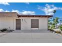 Tan single-story home with simple landscaping and a concrete driveway under a partly cloudy sky at 2635 Heritage Ct, Las Vegas, NV 89121