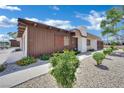 A charming home featuring brown wood and white brick under a bright blue sky at 2635 Heritage Ct, Las Vegas, NV 89121