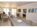 Bright and spacious living area and dining with tile flooring, modern decor, and access to a balcony at 270 E Flamingo Rd # 223, Las Vegas, NV 89169