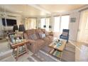Comfortable living room featuring a plush sofa, accent chair, decorative lamps, and stylish area rug at 270 E Flamingo Rd # 223, Las Vegas, NV 89169