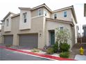 Two-story townhome with attached garage and desert landscaping, showcasing modern design at 2761 Frosted Teal Ave, North Las Vegas, NV 89086