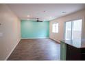 Bright living room with wood floors, a ceiling fan, a large window and sliding glass door at 2761 Frosted Teal Ave, North Las Vegas, NV 89086