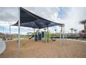 Community playground with shade structure, providing a fun and safe environment for children to play at 2761 Frosted Teal Ave, North Las Vegas, NV 89086