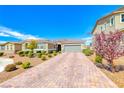 Charming single story home with desert landscaping, stone accents, and a brick paver driveway at 2910 Monate Ct, Henderson, NV 89044