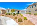 Inviting single story home featuring desert landscaping and a brick paver driveway at 2910 Monate Ct, Henderson, NV 89044