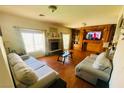 Inviting living area featuring a fireplace, wood floors, and a large decorative cabinet at 3301 W Colton Ave, North Las Vegas, NV 89032
